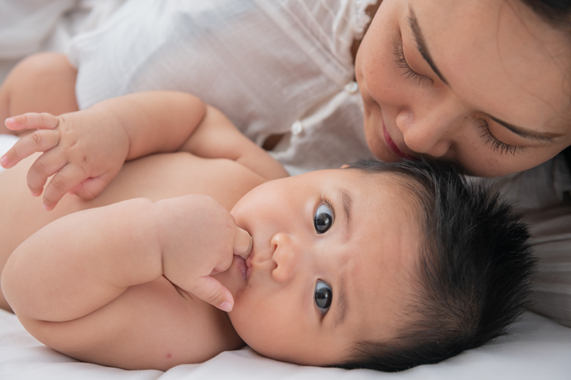 Loving mom carying of her newborn baby at home.