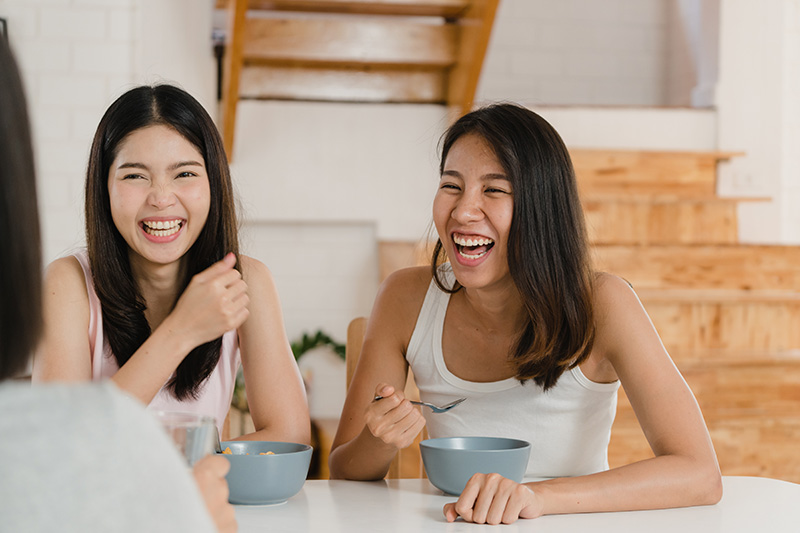 Group of friends having breakfast at home